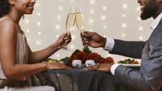 A couple drinks champagne on a date