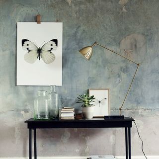 room with painted wallpaper on wall and black wooden table