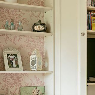 shelves with picture frame and wallpaper wall