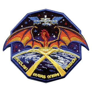 an embroidered 10-sided patch depicting a space station, a mythological dragon and Earth, the latter with criss-criossing contrails forming the roman numeral "X".