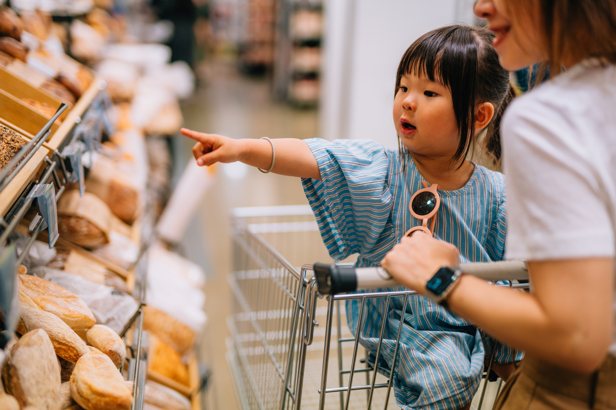 Mum and young daughter shopping at the supermarket