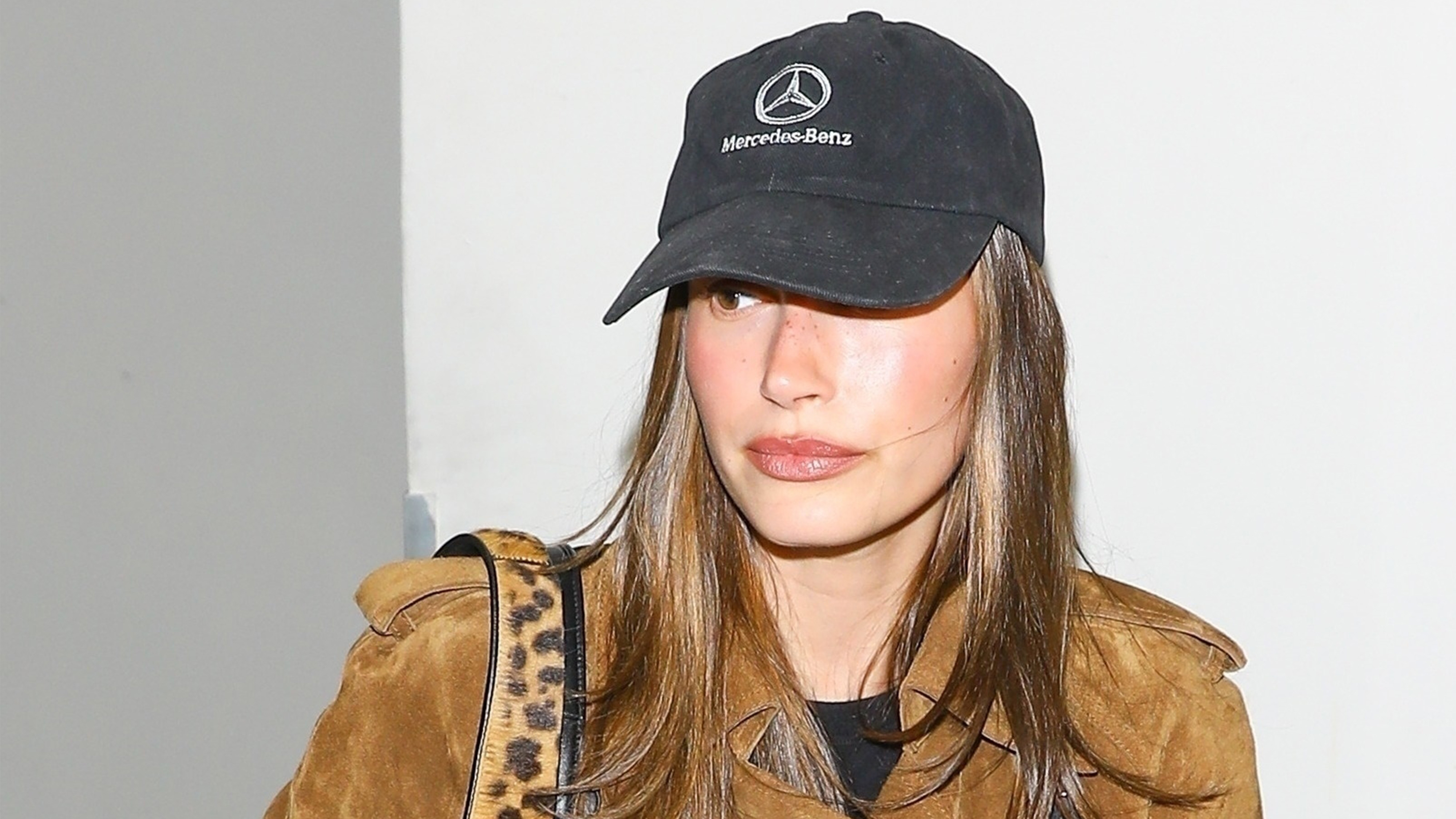 Hailey bieber wears a mercedes benz hat and suede jacket.