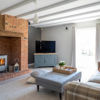 living room with white wall and brick wall chimney