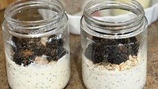 Two jars of overnight oats topped with blackberries