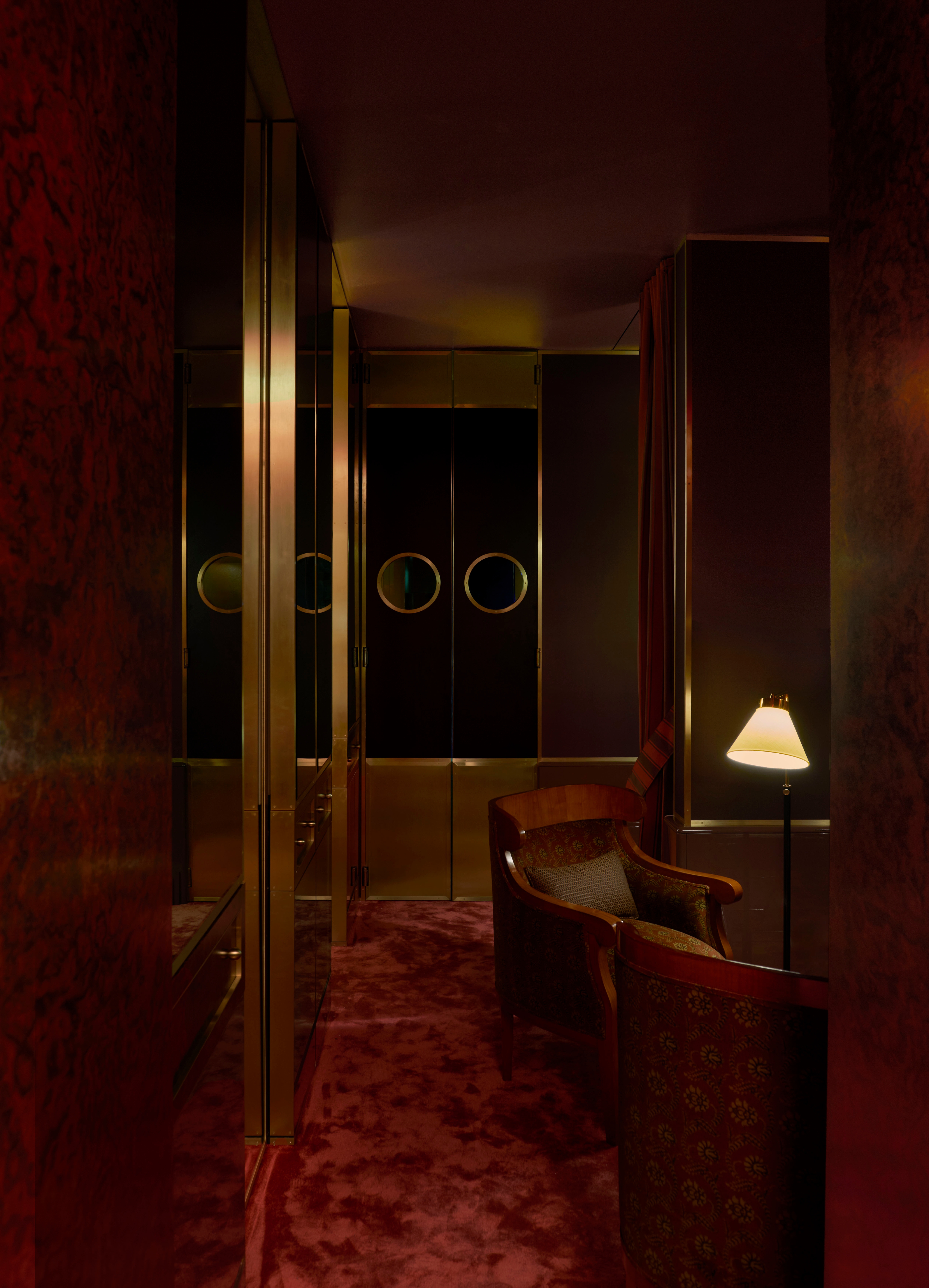 a small restaurant with glamorous red interiors and moody lighting