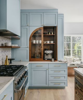 blue pantry cupboard with wooden larder accents