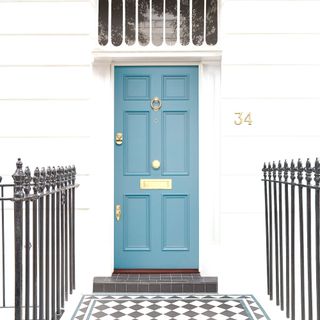 blue georgian door in whitewashed georgian home