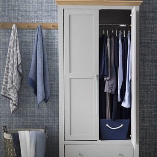 white wardrobe with wall hanger and basket
