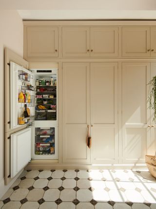 peach cabinetry with a fridge door open