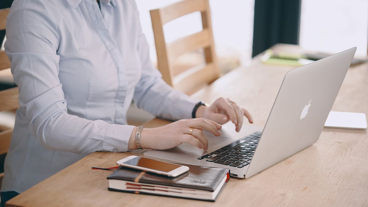 A person using a laptop at home.