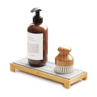 A kitchen caddy with a soap dispenser and washing brush