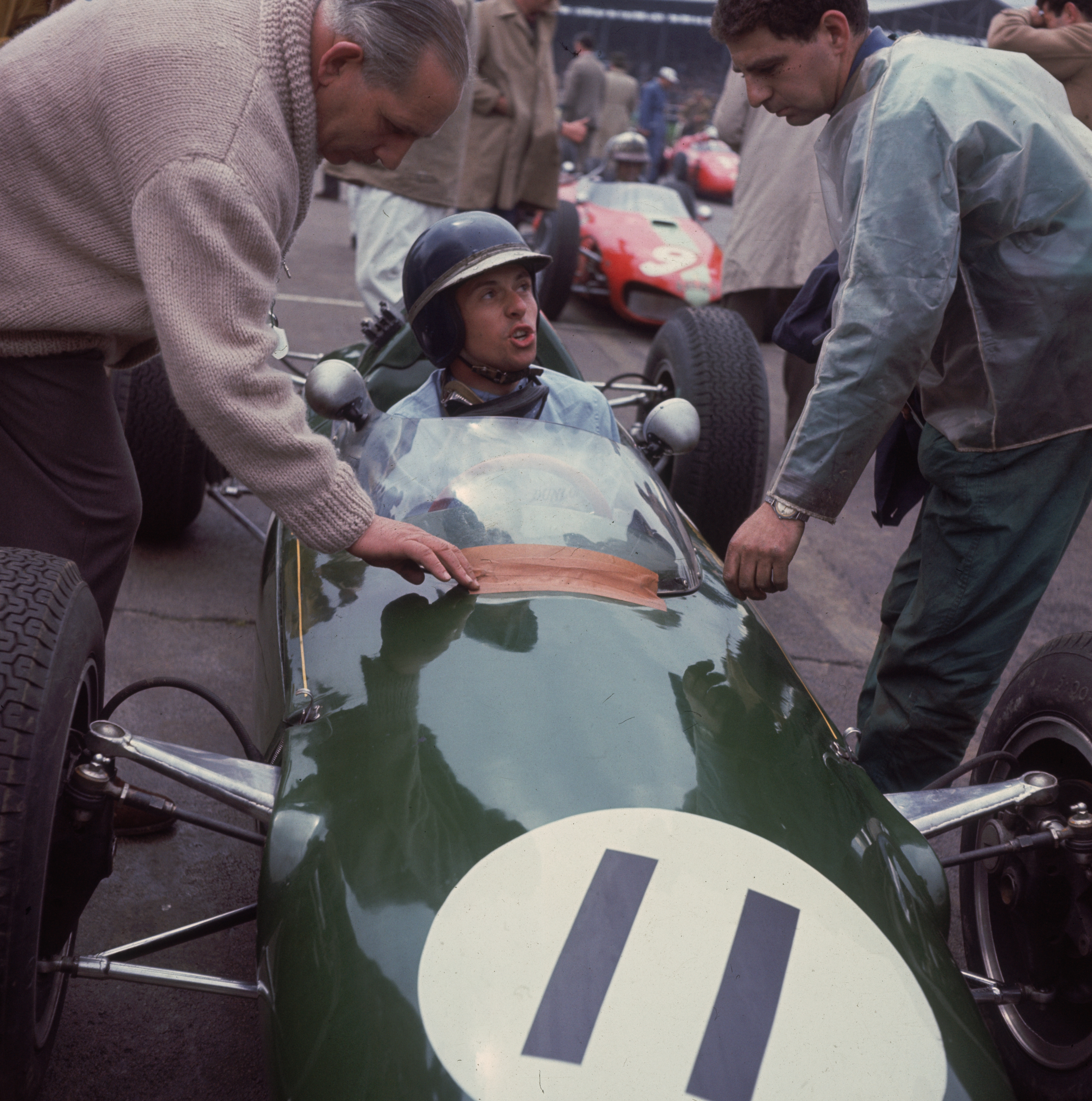 Jim Clark talks to his mechanic from his number 11 race car