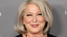 bette midler on a gray background