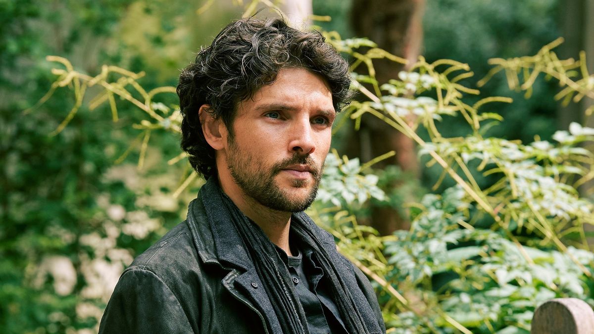 Colin Morgan sitting on a park bench in the Prime Video series, Mammals.