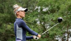 Nelly Korda hits a tee shot with her driver and watches its flight