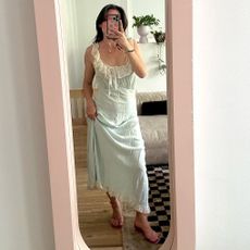 fashion editor Tara Gonzalez poses for a mirror selfie wearing pink Chloe ankle-strap jelly sandals and a lace-trim slip dress