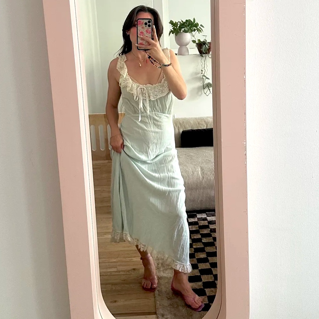 fashion editor Tara Gonzalez poses for a mirror selfie wearing pink Chloe ankle-strap jelly sandals and a lace-trim slip dress
