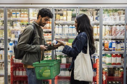 a young couple grocery shopping 