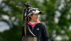 Rose Zhang looks at a trophy