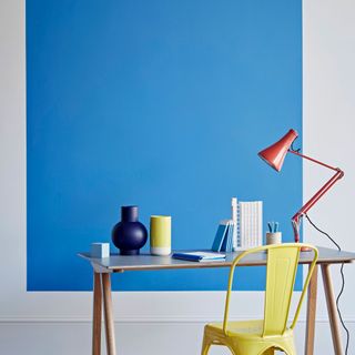 room with office desk and blue wall