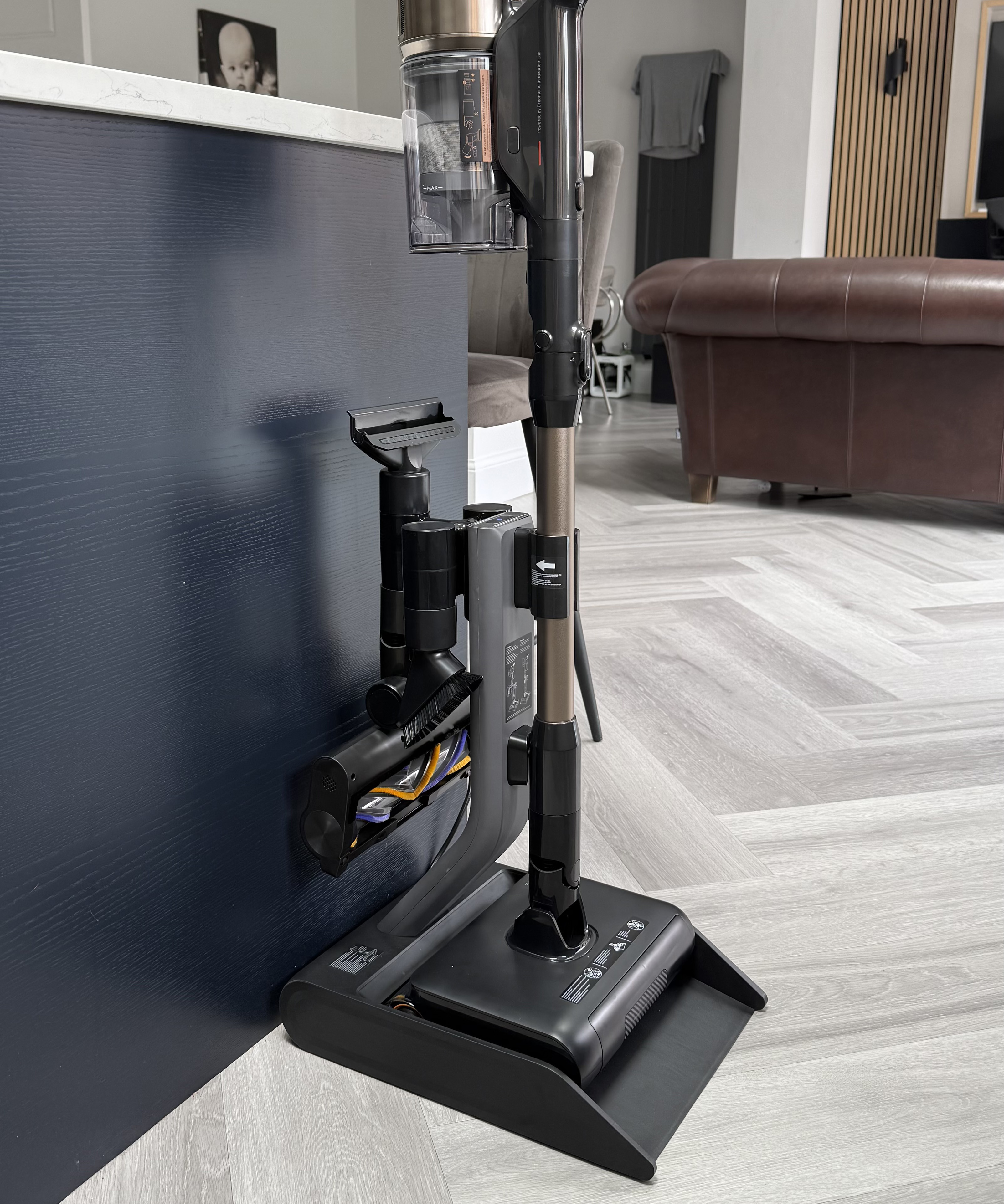 Dreame Z30 Pro Aqua vacuum cleaner mounted on its charging dock with extension wand and accessory tools attached