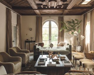 neutral living room with wooden ceiling, neutral armchairs and chaise longue
