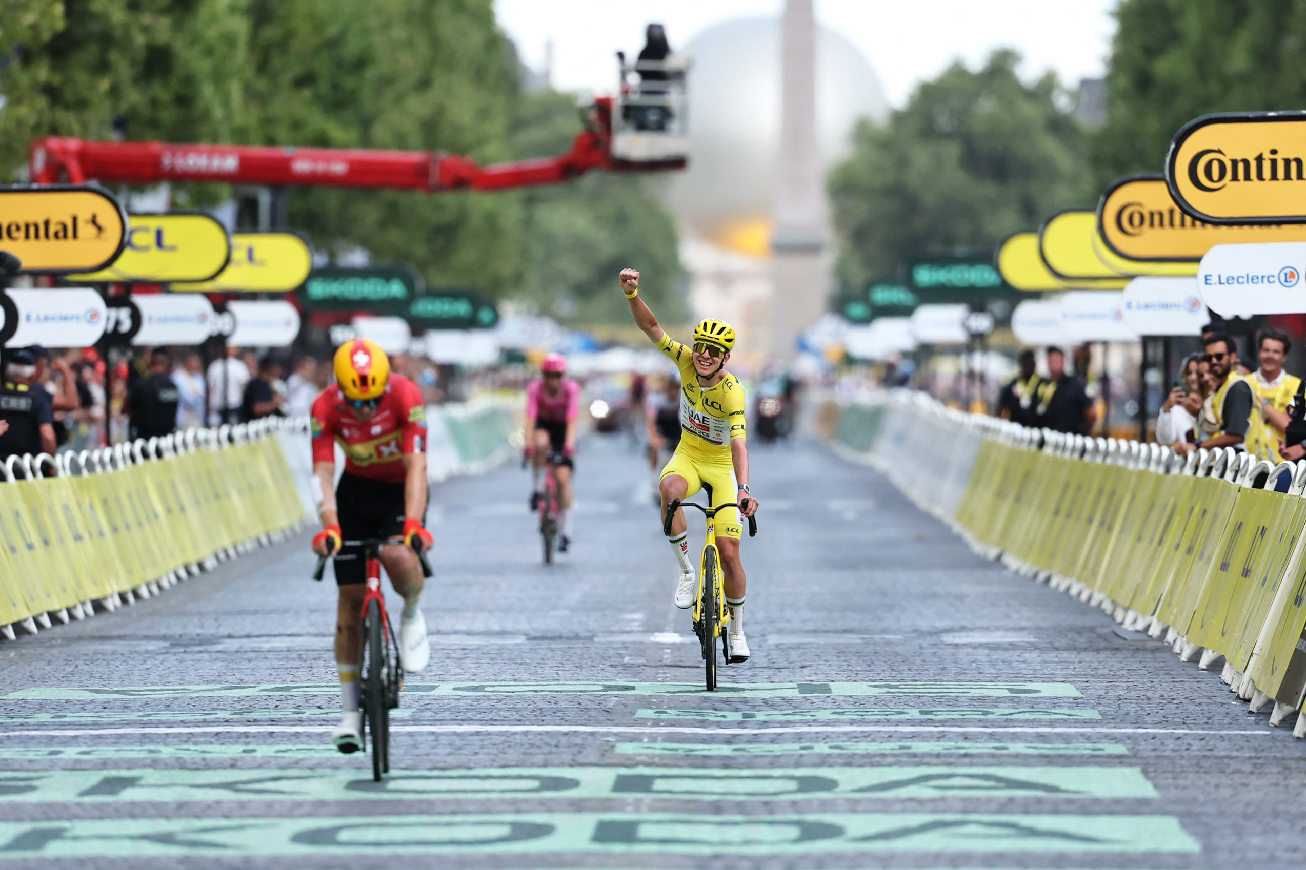 UAE Team Emirates - XRG's Slovenian rider Tadej Pogacar celebrates his overall victory as he crosses the finish line of the 21st stage of the 113th edition of the Tour de France cycling race, 88,7 km starting and finishing in Paris, on July 26, 2026. (Photo by Anne-Christine POUJOULAT / AFP)