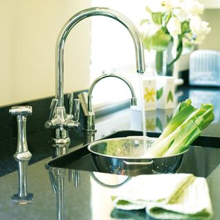 kitchen black worktop with taps