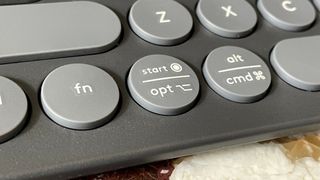 The Start/Option button on the Logitech Pebble Keys 2 K380S keyboard.