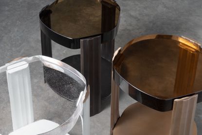 Side tables with irregularly shaped thick glass tops in light brown, dark brown, and clear