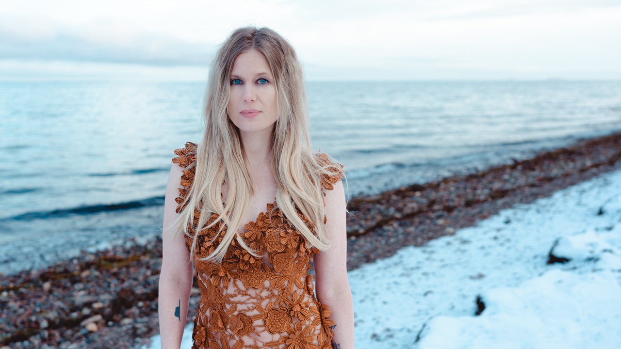 Myrkur press image 2026, Amalie Bruun stands on a snow-covered beach