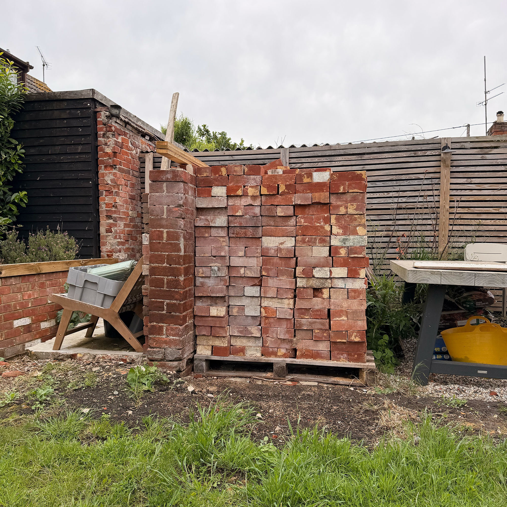 Large pile of bricks in garden