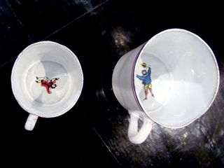 White tea cups with artwork in cup
