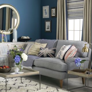 grey sofa in living room with blue walls