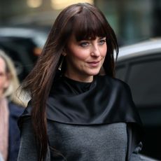 Dakota Johnson was spotted in L.A. wearing a brown wrap coat and black knee-high boots