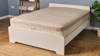 The Birch Luxe Natural mattress on a white bed frame in a open bedroom