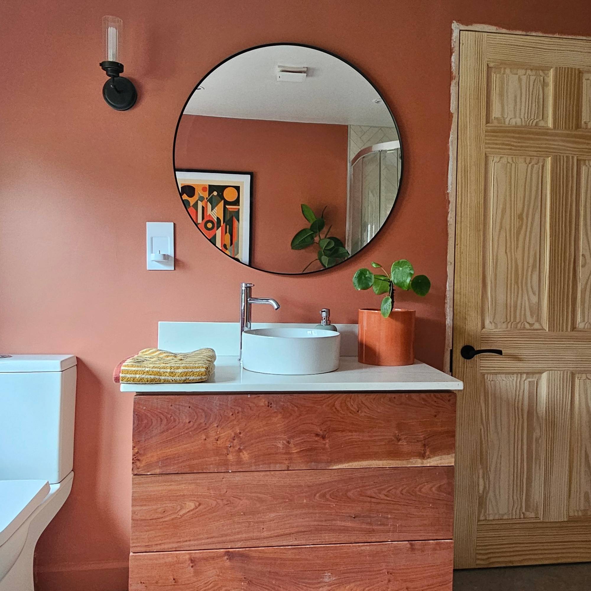 red bathroom with wood and quartz vanity unit