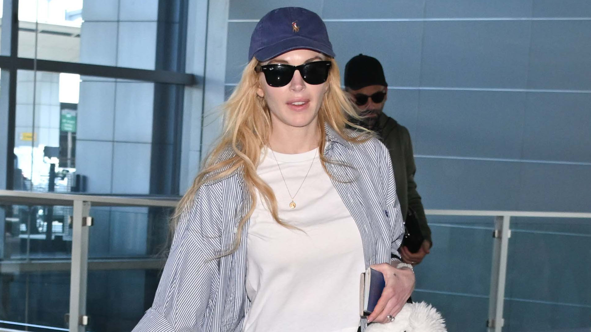 Lindsay Lohan was spotted at JFK airport in chunky white On sneakers
