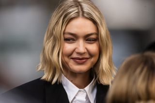 A photo of Gigi Hadid wearing a suit and a wavy blonde bob haircut