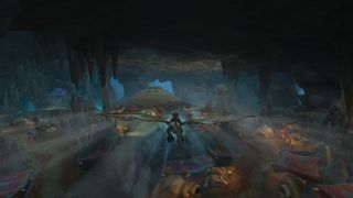 WoW 10.1 update - a player flying their dragonriding mount through a huge cavern