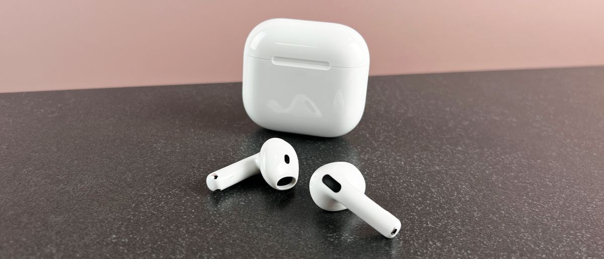 AirPods 4 outside their case on a dark surface