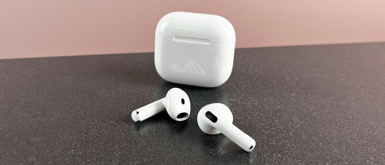 AirPods 4 outside their case on a dark surface