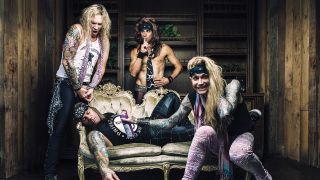 A press shot of Steel Panther lying on a sofa