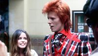 English singer and songwriter David Bowie (1947 - 2016) at Union Station, Los Angeles, with model Patty Clark of Star magazine, California, March 1973.