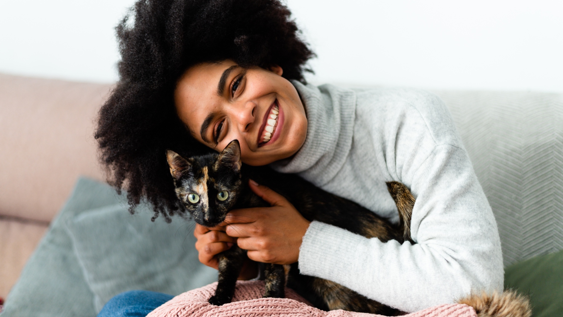 Woman hugging kitten