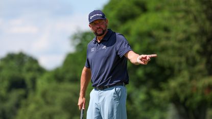 Michael Block points after holing a putt