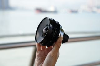 someone holding the 12mm Laowa VV Cine Lens