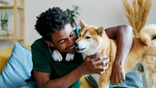 Young man and akita dog