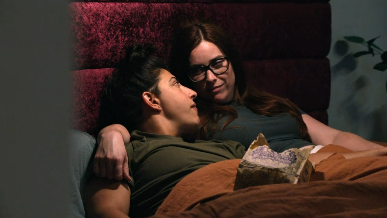 Haley and Magan looking at each other in bed in The Ultimatum: Queer Love Season 2.