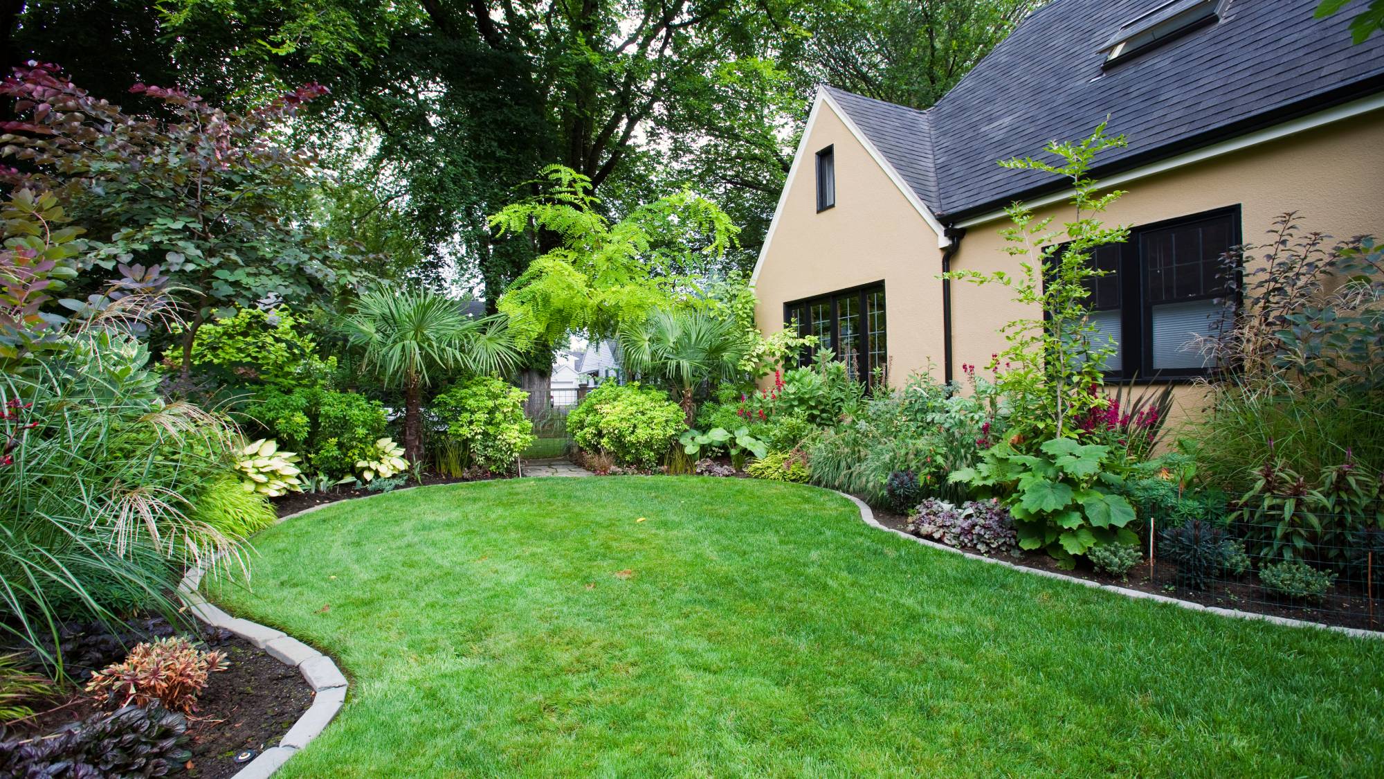 Beautiful lawn and garden next to house